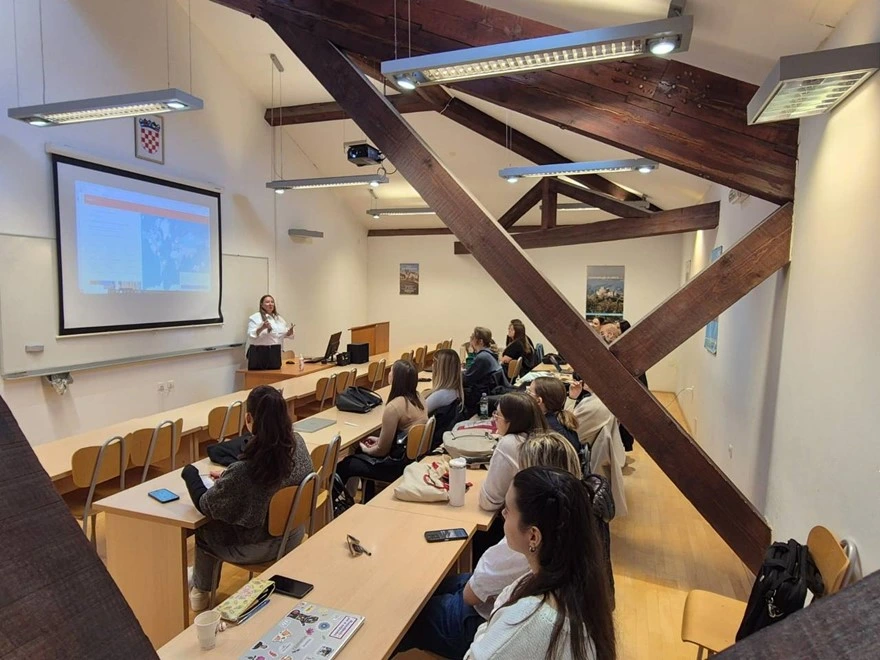 Dr. Darling lecturing to a full audience in a European seminar hall
